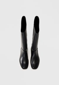 Black knee-high leather boots with a smooth texture, square toe design, and minimalistic silhouette. Zipper closure on the side.