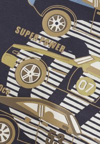 Marineblått stoff med gyldne og hvite grafiske illustrasjoner av vintagebiler, med fet tekst som sier "SUPER POWER" og tallene 07 og 53.