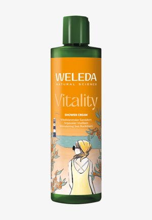 Crema doccia Vitality di Weleda in una bottiglia di plastica verde, con un'etichetta arancione che mostra illustrazioni di una spiaggia e di un'olivella spinoso.