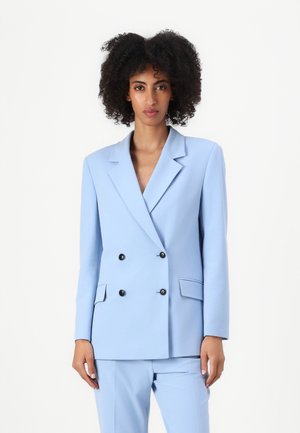 Dobbeltspent lyseblå blazer, skreddersydd passform, med svarte knapper, hakket krage og sidelommer. Jevn tekstur, strukturert design.