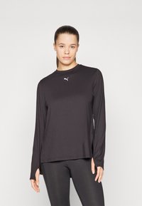 Black long-sleeve athletic top made of a smooth, lightweight fabric. Features a crew neckline and small white logo on the chest.