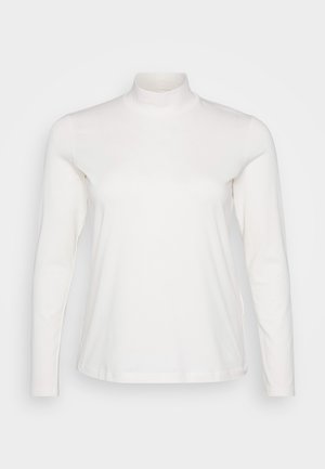 Pitkähiha, korkeakauluksinen valkoinen toppi, joka on valmistettu pehmeästä kankaasta. Ominaisuuksiin kuuluu istuva muotoilu ja sileä rakenne, jossa on vain vähän saumoja.