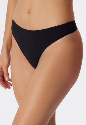 Bas de bikini noir avec un design élégant et minimaliste. Présente des côtés fins, une taille basse et une texture de tissu lisse.