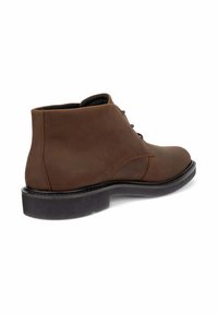 Bruine leren enkelboot met een gladde structuur, ronde neus en tonale veters. Voorzien van een zwarte rubberen zool en subtiele stikseldetails.