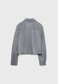 Krótka kurtka w szarej kratę houndstooth z długimi rękawami, kołnierzem w szpic i zapinanymi mankietami, wykonana z teksturowanej tkaniny.