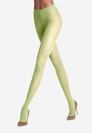 Collant verde chiaro realizzati in materiale opaco, con una texture liscia e una vita alta, abbinati a scarpe con tacco alto beige.
