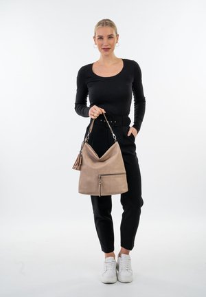 Beige hobo bag with a textured finish, a front zipper pocket, and a decorative tassel. Features a single shoulder strap.