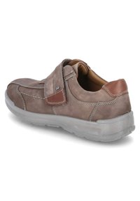 Light brown leather shoe with a velcro strap, gray rubber outsole, and white stitching. Rounded toe and cushioned interior for comfort.