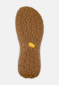 Semelle extérieure Vibram en caoutchouc beige avec des crampons circulaires pour une meilleure traction, arborant un logo hexagonal au centre et la taille 38 indiquée sur le côté.