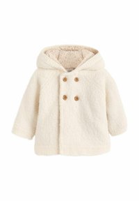 Valge villane kapuutsiga jope, millel on tekstureeritud välimus, kaks puust nuppu ja pehme, karvane vooder. Jope omab raglanvarrukaid ja sirget lõiget.