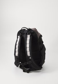 Black backpack with padded straps featuring gray detailing, mesh panels, adjustable buckles, and a solid textured exterior.