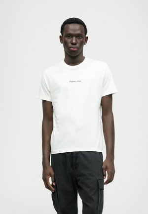 White short-sleeve t-shirt featuring a small "REPLAY" logo in black, worn with black cargo pants, displaying a smooth texture and classic fit.