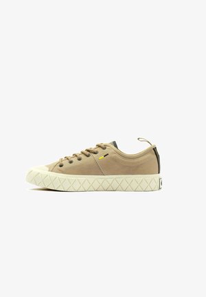 Beige canvas sneaker with a textured upper, round toe, and contrasting navy heel patch. Features yellow accent and a diamond-patterned sole.