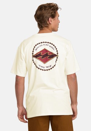 Cream-colored, short-sleeve t-shirt featuring a large graphic of stylized waves in red and brown on the back, with a circular text border.