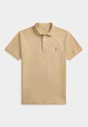 Bež kratkih rukava Polo Ralph Lauren polo majica s dva gumba i izvezenim logom konja na lijevoj strani prsa.