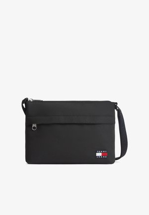 Sort rektangulær skuldertaske med lynlåslomme foran, justerbar rem og Tommy Jeans-logo på nederste højre hjørne.