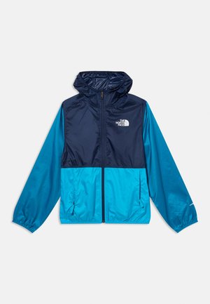 Dvivienė mėlynos spalvos North Face gobtuvu vėjas atstumianti striukė su priekyje esančia užtrauktuku ir elastingomis rankogaliais, parodyta ištiesus ant balto fono.