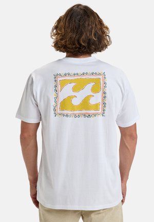 White cotton t-shirt featuring a colorful wave design within a rectangular border on the back. The design includes yellow and green accents.