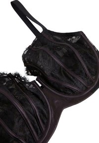 Sort blonde bh med struktureret underwire, lodrette sømdetaljer og bløde stofstropper. Tekstureret blondeoverlæg giver dybde og kontrast.