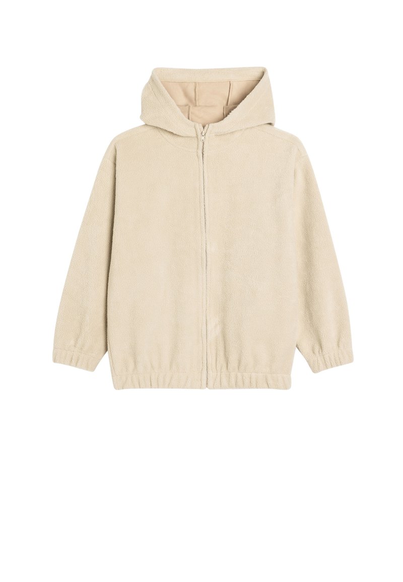 Veste à zip beige en molleton doux. Présente une capuche, des poignets élastiques et un ourlet inférieur. Intérieur lisse avec un design simple et minimaliste.