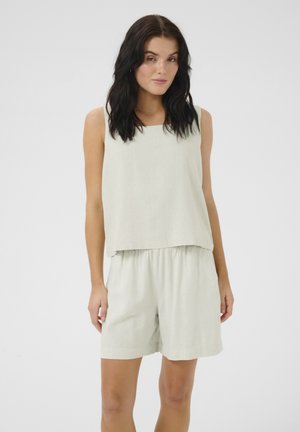 Light green two-piece outfit made of linen, featuring a sleeveless top and elastic waist shorts, smooth texture, minimalistic design.
