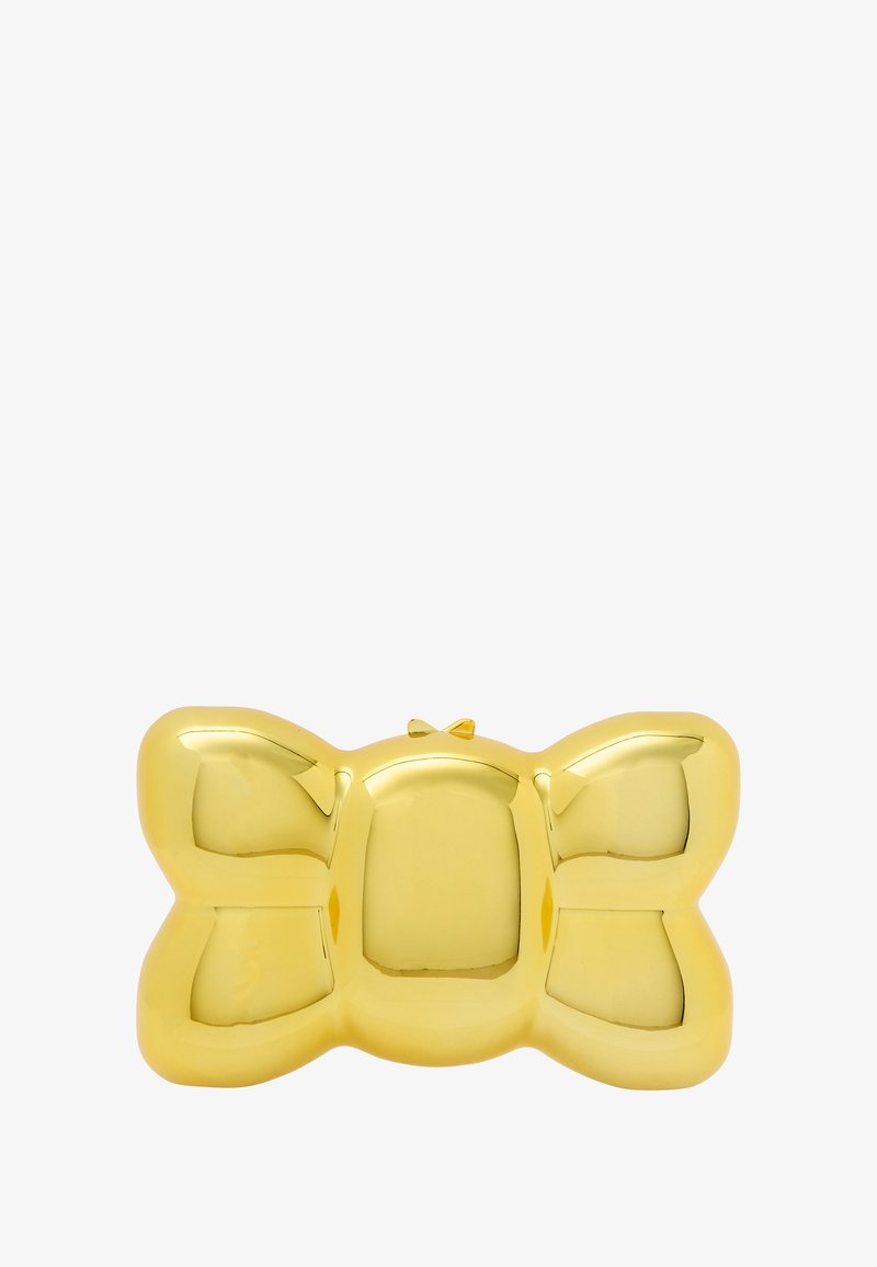 Aranyszínű, masni formájú clutch táska, sima, fényes felülettel és egy kis zárómechanizmussal a tetején.