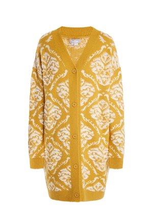 Strikket cardigan i sennepsgul med hvidt blomsterprint. Har V-hals, lange ærmer og fem knapper foran.