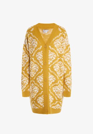 Neulecardigan sinapinkeltainen valkoisella kukkakuviolla. Varustettu V-kaula-aukolla, pitkillä hihoilla ja viidellä napilla edessä.