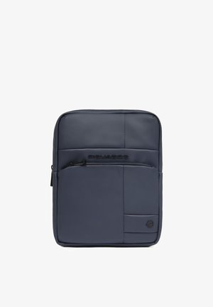 Compact navy blue crossbody bag with front zip pocket, smooth surface, and subtle brand logo on lower right corner.