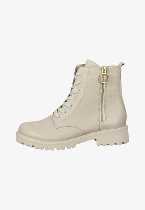 Beige ankle boots featuring a textured leather upper, front laces, and a side zipper with gold hardware; chunky, lugged sole for traction.