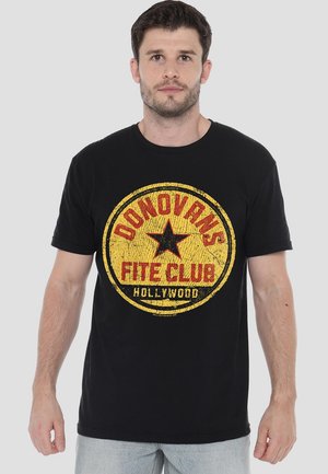 Black cotton t-shirt featuring a distressed yellow and red circular graphic with "DONOVAN'S FITE CLUB" and a star design. Short sleeves.