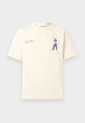 Cream short-sleeve T-shirt with small graphic of a person carrying two baguettes and cursive text "Filling Pieces" on the chest.