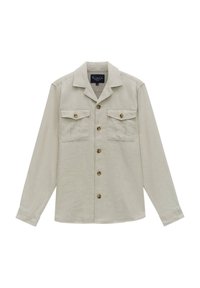 Licht beige langwerpige blouse met lange mouwen, gemaakt van textuurstof, heeft een kraag, een knopenfront en twee borstzakken met kleppen.
