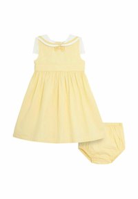 Gelbes Kleid mit tailliertem Oberteil, ausladendem Rock und weißem Kragen. Beinhaltet passende Bloomers. Zarte Textur und eine Schleifendetail im Rücken.