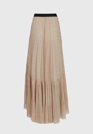Jupe longue beige à pois noirs, taille élastique noire et ourlet volanté plissé.