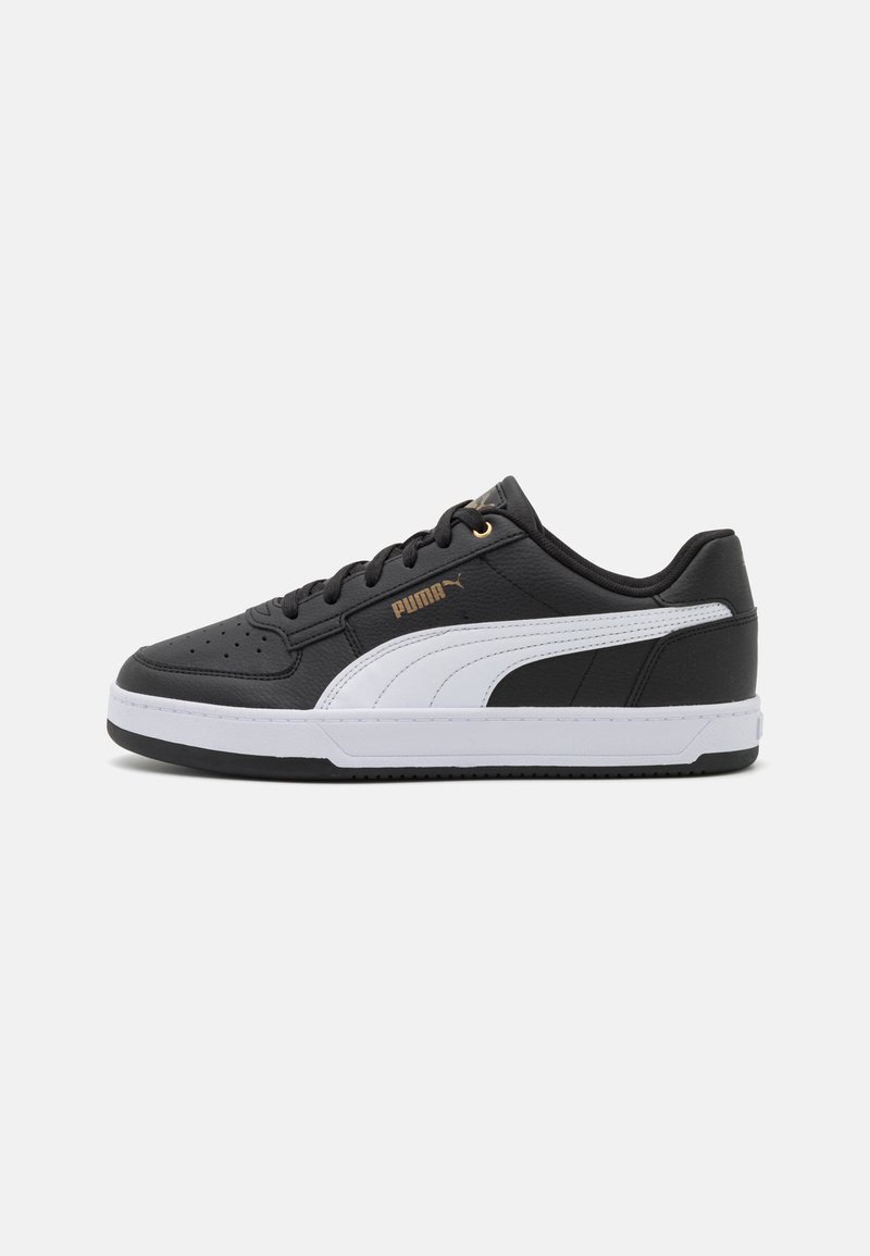 Black athletic sneakers with white accents, leather-like texture, round toe, lace-up design, and gold logo detail on the side.