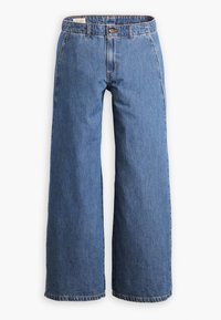 Jean bleu taille haute à jambes larges avec fermeture par boutons, poches avant et coutures visibles sur fond blanc.