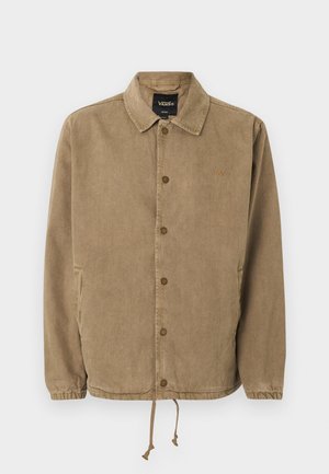 Veste boutonnée marron clair avec col, poignets élastiques, ourlet à cordon de serrage, logo Vans sur l'étiquette intérieure noire et petite broderie sur la poitrine.