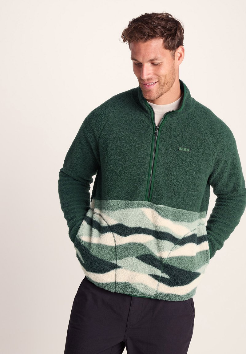 Green fleece pullover with half-zip design. Features front pockets, a textured upper, and a patterned lower section in green and cream.