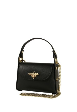 Black leather handbag with a top handle, gold bee embellishment on the flap, gold studs on sides, and a detachable gold chain strap.