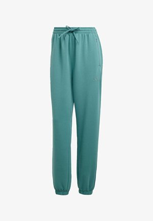 Teal athletic pants made of soft fabric, featuring an elastic waistband, drawstring, and ankle cuffs. Subtle logo detail on the left leg.
