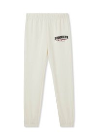 Spodenki dresowe w kolorze kremowym, z elastycznym paskiem w talii, zwężanymi nogawkami oraz czarno-czerwonym logo "Brooklyn Champions" na lewej nodze.
