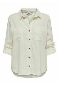 Chemise beige clair à boutons avec deux poches poitrine, manches retroussables et un ourlet légèrement arrondi. Fabriquée en tissu tissé, avec des boutons marron.