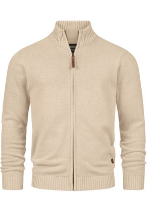 Beige zip-up cardigan med høy ribbestrikket krage og tettsittende mansjetter. Har en myk strikket tekstur og en liten lærlogo detalj ved kanten.
