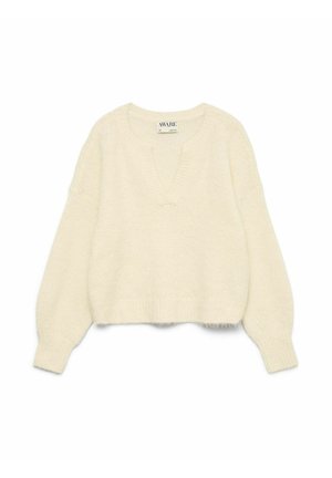 Ivore gebreide trui met een diepe V-hals, lange mouwen en geribbelde zoom. Zachte textuur; iets verkorte stijl met oversized pasvorm details.