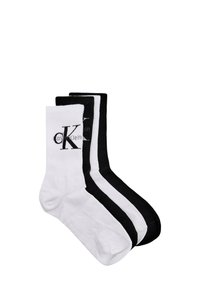 Tre paia di calzini da equipaggio in misto cotone: uno bianco con logo nero, uno bianco con strisce nere e uno completamente nero con logo.