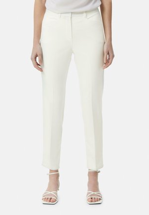 White tailored pants with a smooth texture, featuring a straight-leg design, side pockets, and subtle seam detailing. Paired with strappy white heels.