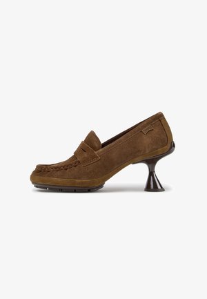Mocassino in camoscio marrone con cuciture mocassino e tacco alto nero svasato su sfondo bianco.