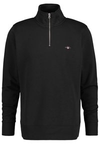 Black zippered sweatshirt with a high collar, made of soft fabric. Features ribbed cuffs and hem, with a small logo on the left chest.