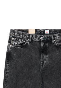 Jeans in denim nero con classico design a cinque tasche, dettagli in metallo e etichetta in pelle sulla vita. Tessuto dalla texture liscia.